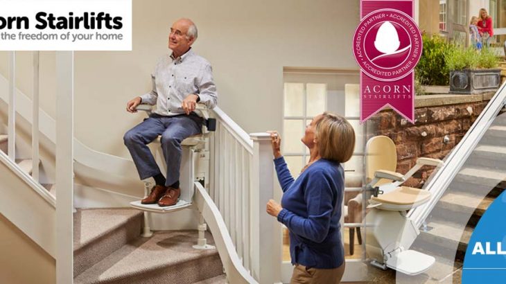Acorn Stairlifts banner with elderly man in stairlift looking happy as female looks on.