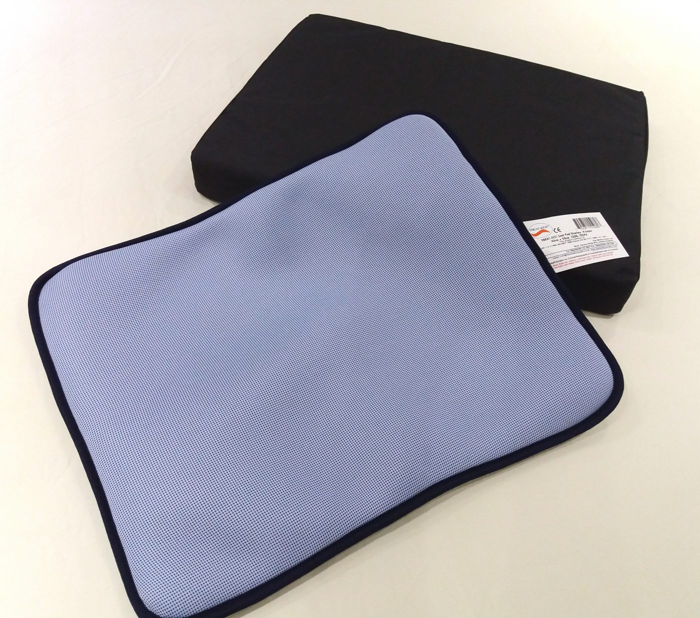 Pale blue seat pad with black cushion.