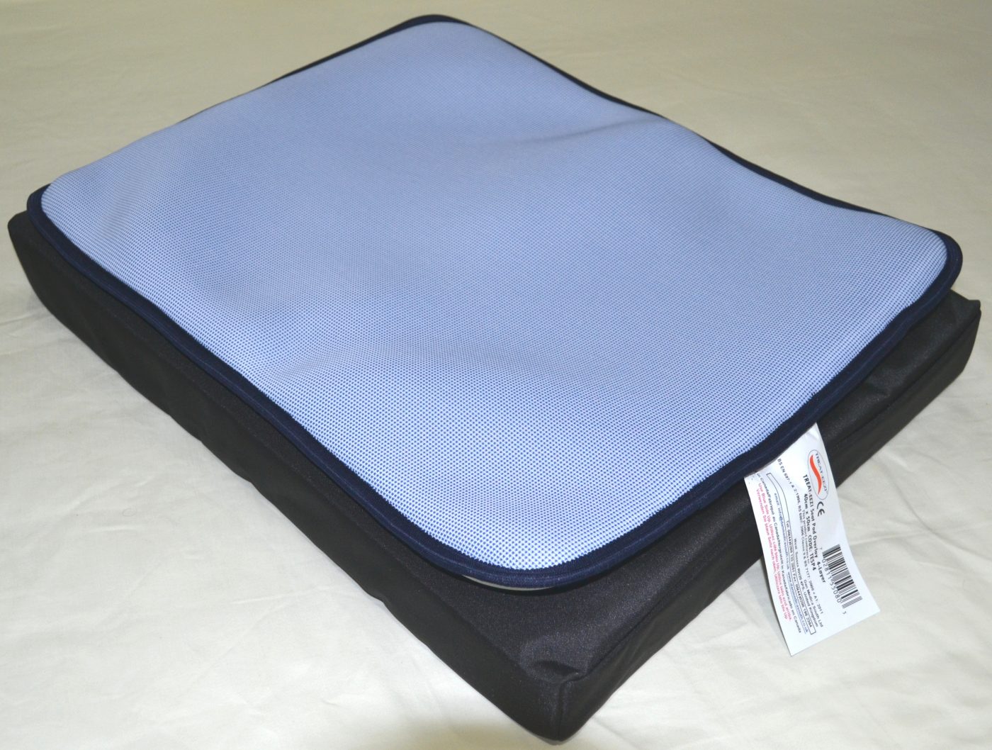 Pale blue seat pad with black cushion.