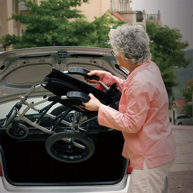 Ergo Lite 2 wheelchair transit easy carry by woman into car boot