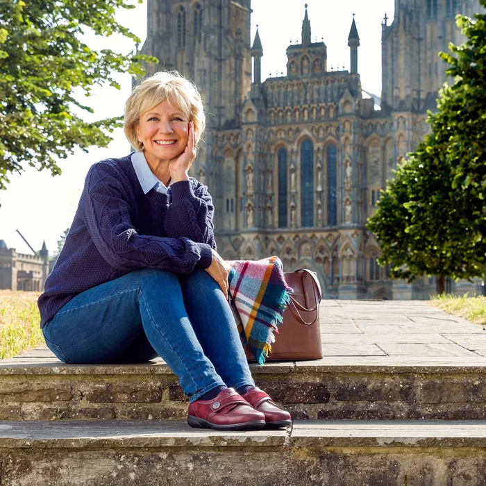Woman sitting on steps outside cathedral