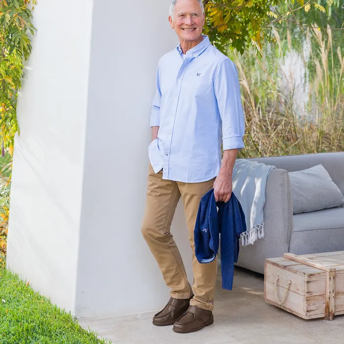 Man leaning on pillar smiling