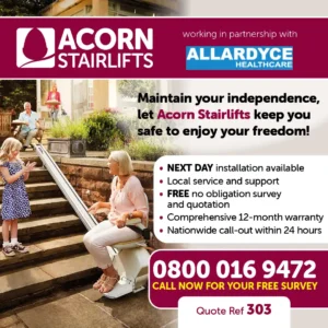 Acorn stairlift with woman on stairlift in garden and family looking on smiling.